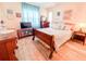 Bedroom with wooden sleigh bed and built-in shelving at 216 Gloucester Blvd # 216, Sun City Center, FL 33573