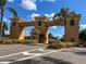 Grand entrance to Kings Point community featuring an arched gateway and lush landscaping at 216 Gloucester Blvd # 216, Sun City Center, FL 33573