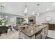 Open concept kitchen with island and views into living and dining areas at 10012 Corso Milano Dr, Tampa, FL 33625