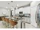 Modern kitchen with white cabinets, granite countertops, and a large island with seating at 10012 Corso Milano Dr, Tampa, FL 33625