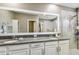 Spa-like bathroom with double vanity, granite countertop, and walk-in shower at 10012 Corso Milano Dr, Tampa, FL 33625