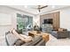 Living area with wooden accent wall, comfortable seating, and large screen TV at 10012 Corso Milano Dr, Tampa, FL 33625