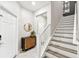 Bright and airy entryway with a staircase, storage console, and mirror at 10012 Corso Milano Dr, Tampa, FL 33625