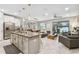 Open concept kitchen with island and stainless steel appliances at 10012 Corso Milano Dr, Tampa, FL 33625