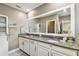 Elegant bathroom with double vanity, granite countertop, and large mirror at 10012 Corso Milano Dr, Tampa, FL 33625