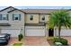 Two-story townhouse with attached garage and landscaping at 10012 Corso Milano Dr, Tampa, FL 33625