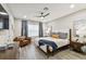 Main bedroom with plush bed, comfortable seating and large window at 10012 Corso Milano Dr, Tampa, FL 33625