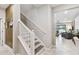 Modern staircase with white railing and gray steps leading to the second floor at 10012 Corso Milano Dr, Tampa, FL 33625