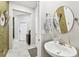 Powder room with white pedestal sink and round mirror at 10012 Corso Milano Dr, Tampa, FL 33625