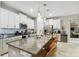 Spacious kitchen featuring granite countertops and an island with seating at 10012 Corso Milano Dr, Tampa, FL 33625