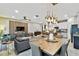 Open concept dining area with a long wooden table and view of the kitchen and living room at 10012 Corso Milano Dr, Tampa, FL 33625