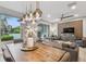 Bright dining room with a wood table, statement light fixture, and view of the backyard at 10012 Corso Milano Dr, Tampa, FL 33625