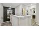 Upstairs hallway with neutral walls and wood-look flooring at 10012 Corso Milano Dr, Tampa, FL 33625