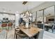 Elegant dining room with a wood table, modern light fixtures, and large mirrors at 10012 Corso Milano Dr, Tampa, FL 33625