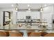 Modern kitchen with white cabinets, granite countertops and a large island with seating at 10012 Corso Milano Dr, Tampa, FL 33625
