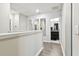 Bright hallway featuring wood-look floors and access to bathroom at 10012 Corso Milano Dr, Tampa, FL 33625