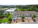 Aerial view of three townhouses with attached garages and lush landscaping at 10012 Corso Milano Dr, Tampa, FL 33625