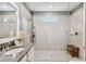 Large walk-in shower with bench seat and multiple shower heads at 10012 Corso Milano Dr, Tampa, FL 33625