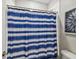 Bathroom with blue striped shower curtain and white tile at 10012 Corso Milano Dr, Tampa, FL 33625