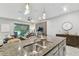 Kitchen island with double sink overlooking living room at 10012 Corso Milano Dr, Tampa, FL 33625