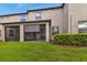 Landscaped backyard with a screened patio at 10012 Corso Milano Dr, Tampa, FL 33625