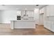 Modern white kitchen with island and stainless steel appliances at 13728 Evergreen Valley Dr, Riverview, FL 33578