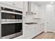 Modern white kitchen with stainless steel appliances and white cabinets at 13728 Evergreen Valley Dr, Riverview, FL 33578
