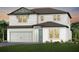 Two-story home with white siding, brown roof, and landscaping at 13728 Evergreen Valley Dr, Riverview, FL 33578