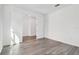 Spacious bedroom with wood-look floors and double doors at 13728 Evergreen Valley Dr, Riverview, FL 33578
