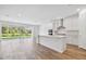 Modern white kitchen with island and stainless steel appliances at 13728 Evergreen Valley Dr, Riverview, FL 33578