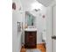 Stylish powder room with a pedestal sink and hardwood floors at 1229 S Roxmere Rd, Tampa, FL 33629