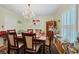 Bright dining room featuring a large table, chandelier, and built-in hutch at 1229 S Roxmere Rd, Tampa, FL 33629