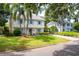 Two story house with a landscaped yard and palm trees in front at 1229 S Roxmere Rd, Tampa, FL 33629