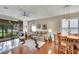 Bright living room with hardwood floors, comfy furniture, and sliding glass doors leading to a patio at 242 Shell Falls Dr, Apollo Beach, FL 33572