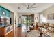 Spacious living area with hardwood floors, large TV, and access to patio at 242 Shell Falls Dr, Apollo Beach, FL 33572