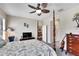 Bedroom with post bed, ceiling fan, and access to bathroom at 242 Shell Falls Dr, Apollo Beach, FL 33572