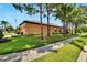 Rear view of tan house, nicely landscaped at 242 Shell Falls Dr, Apollo Beach, FL 33572