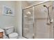 Clean bathroom with a glass shower door and neutral tile at 242 Shell Falls Dr, Apollo Beach, FL 33572