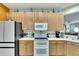 Modern kitchen with white appliances and light wood cabinets at 242 Shell Falls Dr, Apollo Beach, FL 33572
