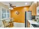 Small kitchen area with orange accent wall and breakfast nook at 242 Shell Falls Dr, Apollo Beach, FL 33572