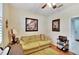 Home office with a light green couch, wooden desk, and ceiling fan at 242 Shell Falls Dr, Apollo Beach, FL 33572