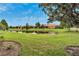 Tranquil community pond with lush landscaping and homes reflecting in the water at 242 Shell Falls Dr, Apollo Beach, FL 33572