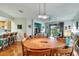 Elegant dining room featuring a round wooden table with seating for six and hardwood floors at 242 Shell Falls Dr, Apollo Beach, FL 33572