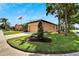 Side view of a tan house with lush landscaping at 242 Shell Falls Dr, Apollo Beach, FL 33572