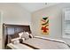 Well-lit bedroom featuring a king-size bed and tasteful wall art at 242 Shell Falls Dr, Apollo Beach, FL 33572