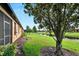Landscaped backyard oasis with a pond view at 242 Shell Falls Dr, Apollo Beach, FL 33572