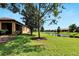 Backyard with pond view and lush landscaping at 242 Shell Falls Dr, Apollo Beach, FL 33572