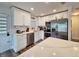 Modern kitchen with white shaker cabinets, stainless steel appliances, and quartz countertops at 10007 N 22Nd St, Tampa, FL 33612