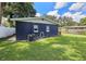 View of the home's rear showcasing a large backyard and AC unit at 10007 N 22Nd St, Tampa, FL 33612