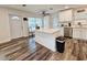 Modern kitchen with white cabinets, quartz countertops, and stainless steel appliances at 10007 N 22Nd St, Tampa, FL 33612